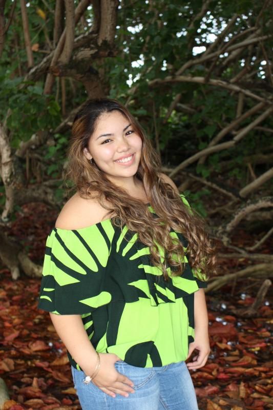 A portrait, wearing Green Hawaiian print blouse