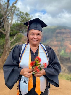 Cap and gown with lehua blossoms at Koke'e