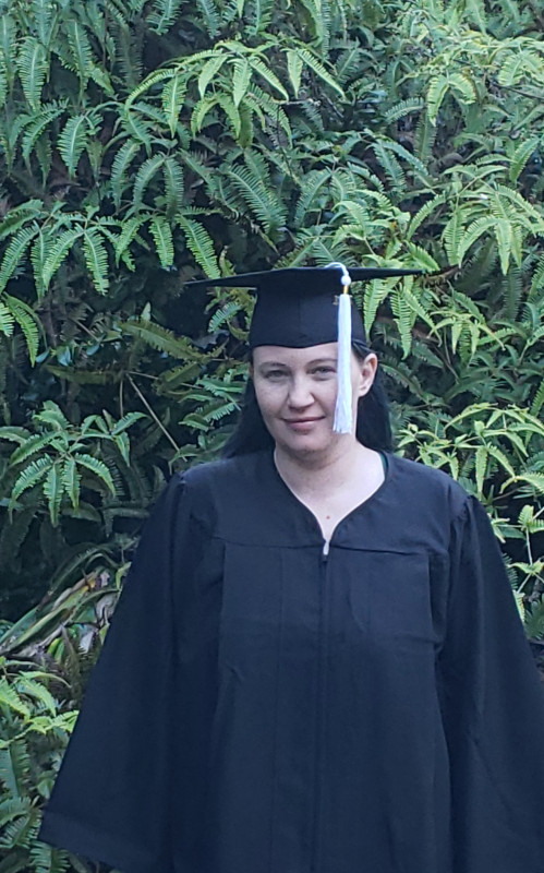 Standing in front of greenery