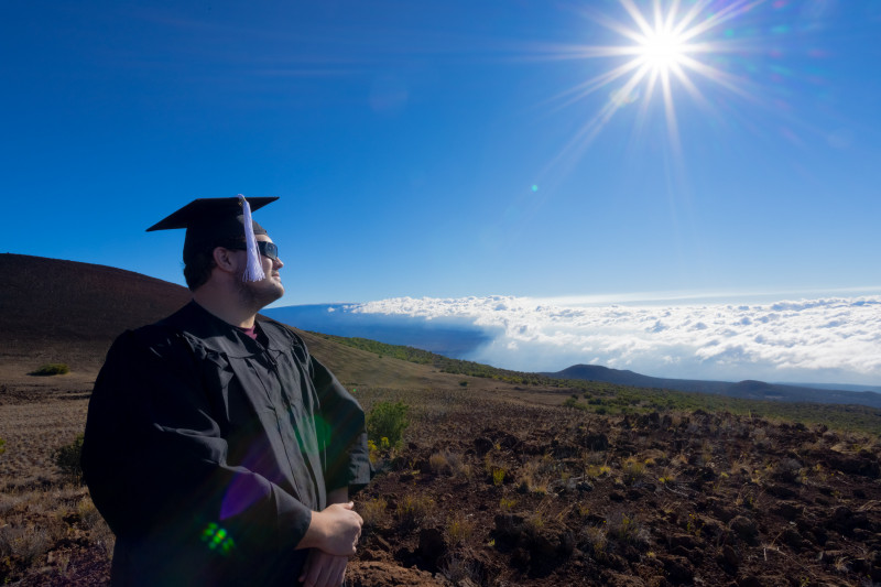 Photo is of me on Mauna Kea. The sky is Clearly seen in the background with the sun Shining brightly