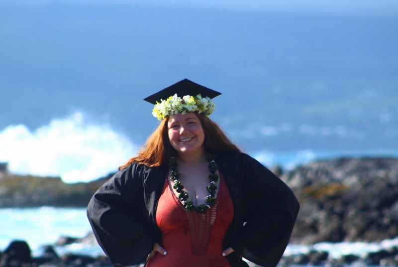 Reve at Chock's beach taking graduation photos in cap and gown