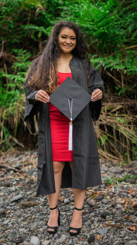 Talen Holding cap and dressed in gown