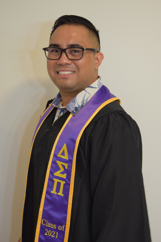 picture of me with my gown and Dsp sash
