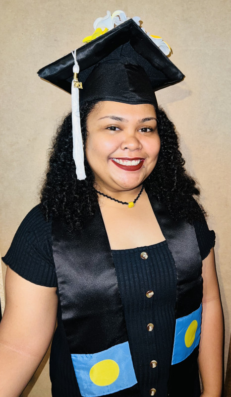 Wearing my cap and graduation sash representing my home country of Palau