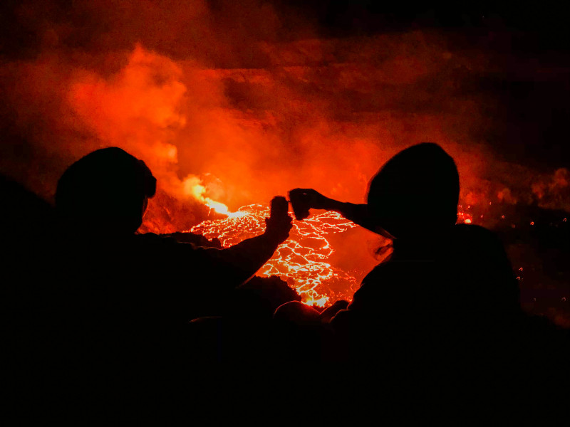 My friend and I enjoying a drink at the edge of Halemaʻumaʻu crater