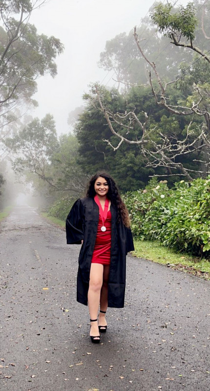 Talen with gown and Pi Alpha Sigma medal