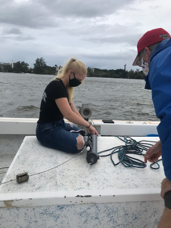 I am sitting on a boat with my professor and I have a Niskin bottle in front of me for lab.