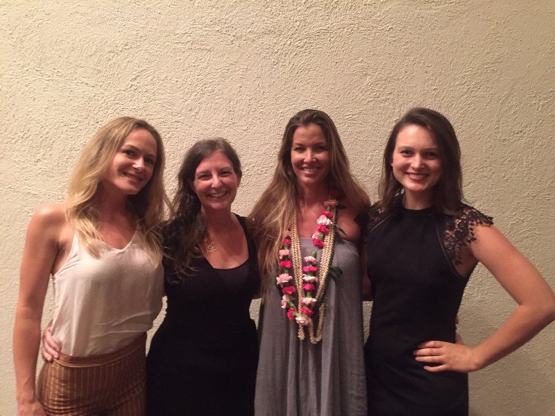 Four women standing in a group for a photo opportunity.