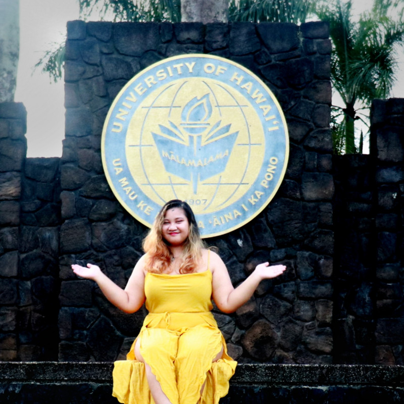 a picture of me posing in front of the UH Hilo logo