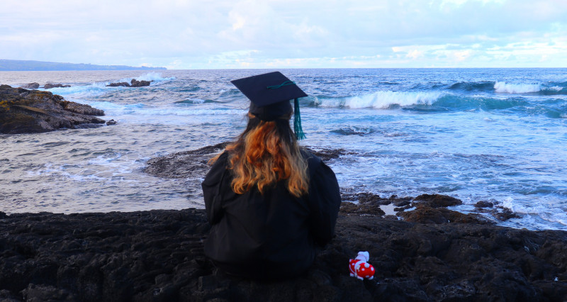 facing the ocean in my graduation outfit with Ani by my side