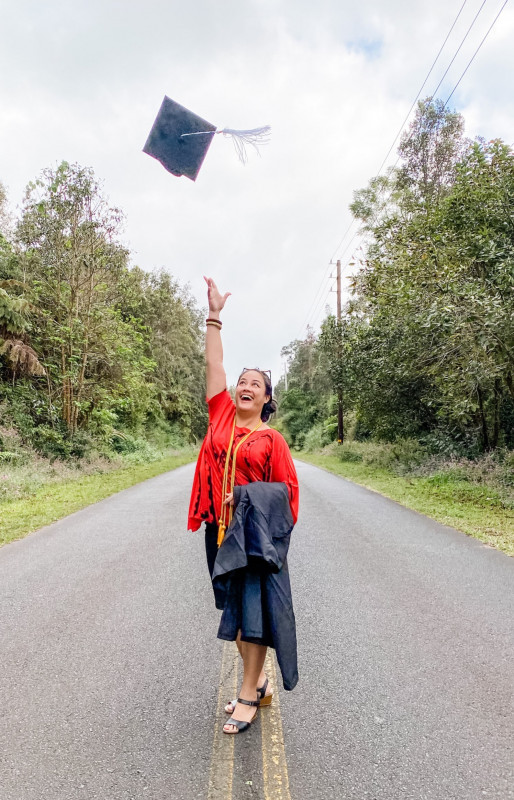 Full-length photo standing in the middle of the street and tossing my graduation cap into the air.