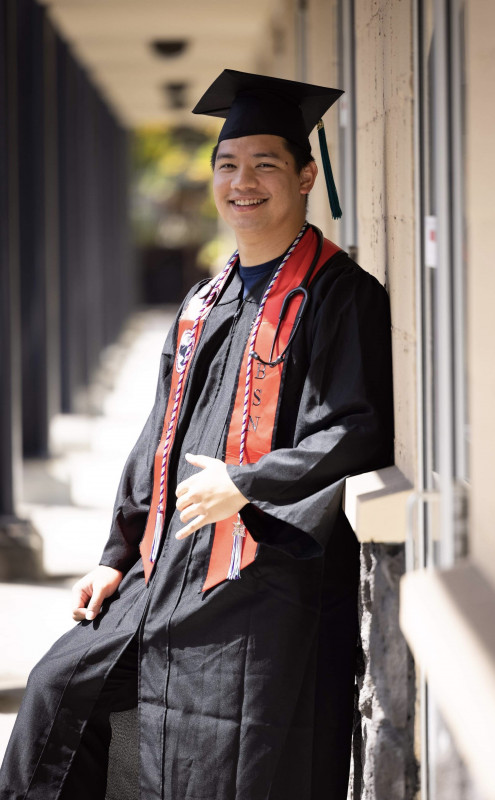 This is my primary photo. It is of me in my cap and gown and other graduation attire.