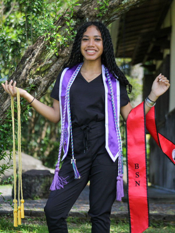 Graduate in black scrubs