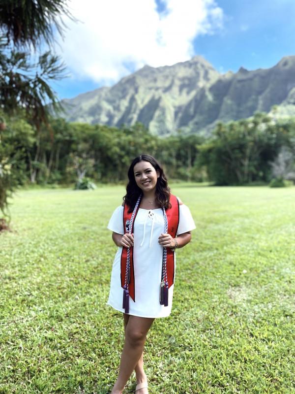 white dress, mountains, graduation stole and cords