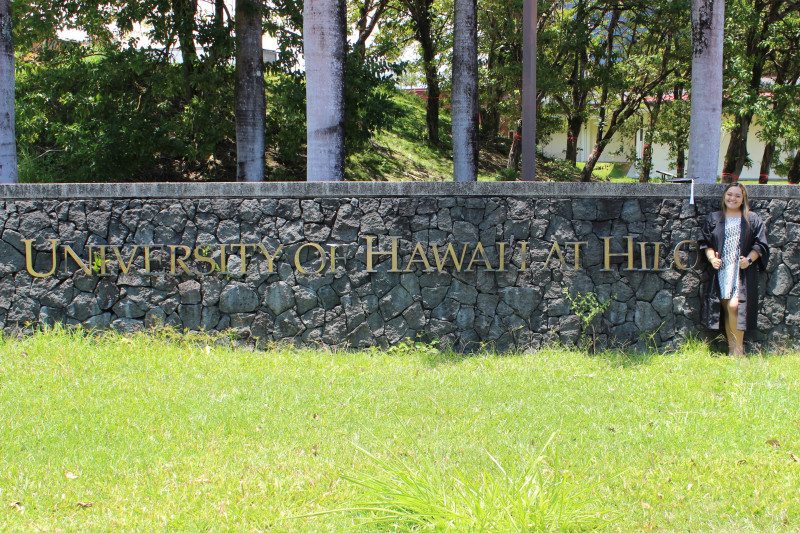 photo in front of "UH Hilo" sign