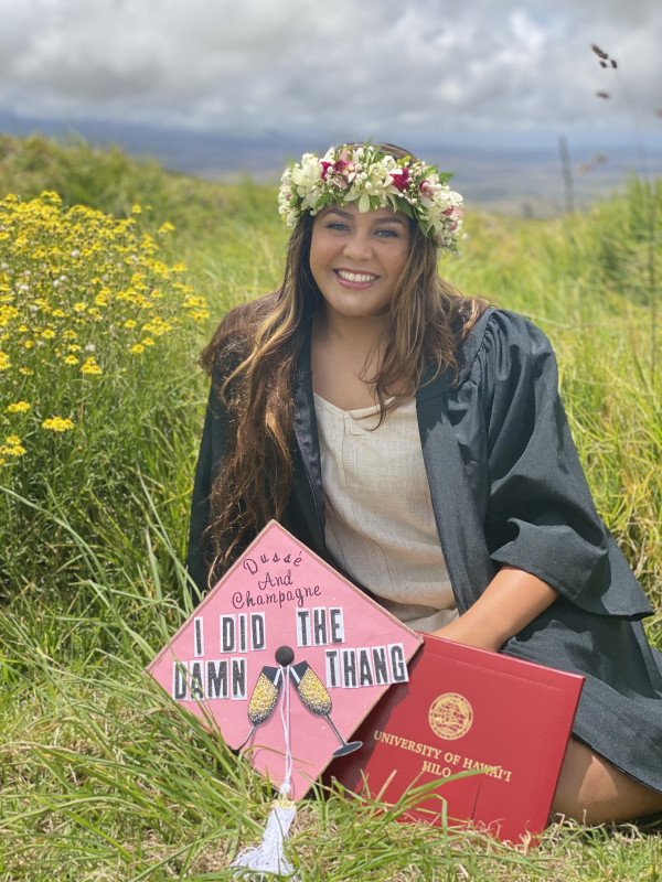 Vevesi Ariana Hope Liilii smiling in a sitting pose with her decorated cap & KES diploma.