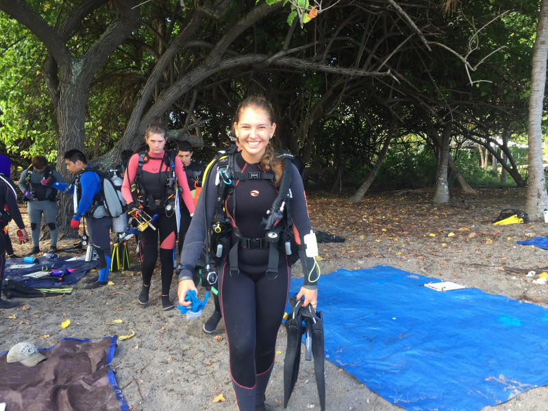 Alexa Runyan suited up and preparing to enter the water as dive team leader for QUEST (Quantitative Underwater Ecological Surveying Techniques) Field School May 2019.