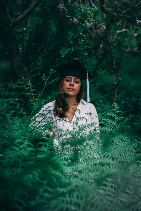 Kaitlyn standing in a thick understory of ferns.