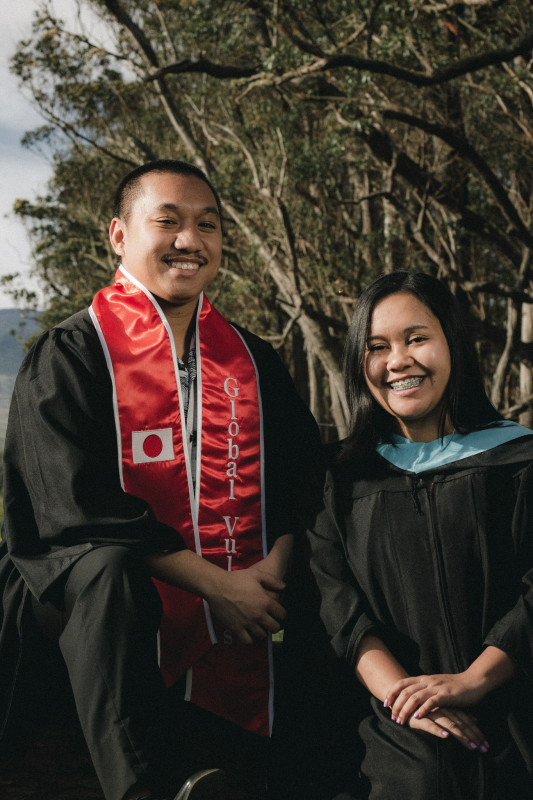 Robert standing with another graduate