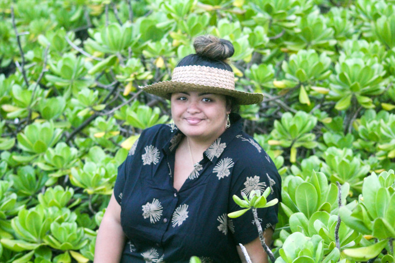 A self portrait of myself in a black dress and a field of naupaka kahakai