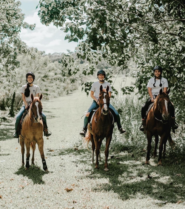 Ariana, Megan, and Daisy riding horses.