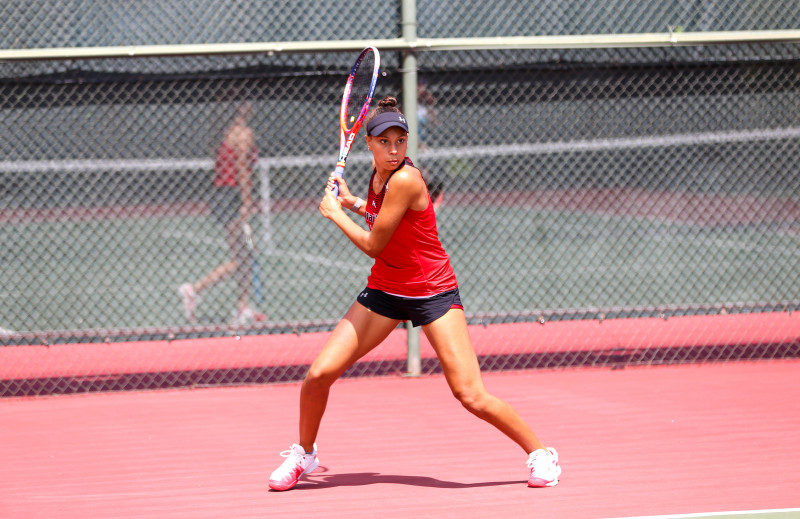 Carmelle playing tennis for UH Hilo Vulcans