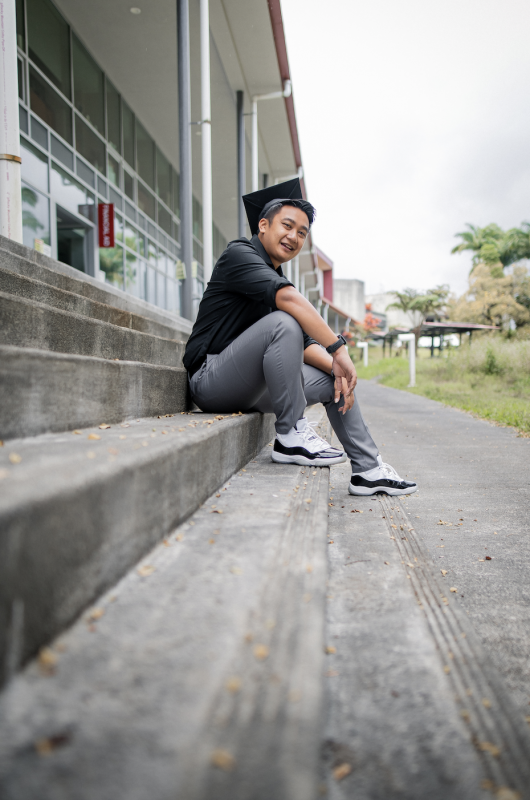 “Male student sitting on stairs.”