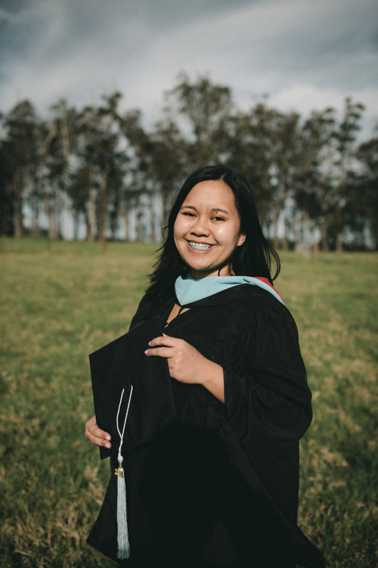 Gladys Ann Soliven Torrano standing in a cap and gown