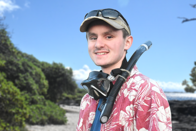 Grant Sanderson standing with a dive mask and snorkel around his neck