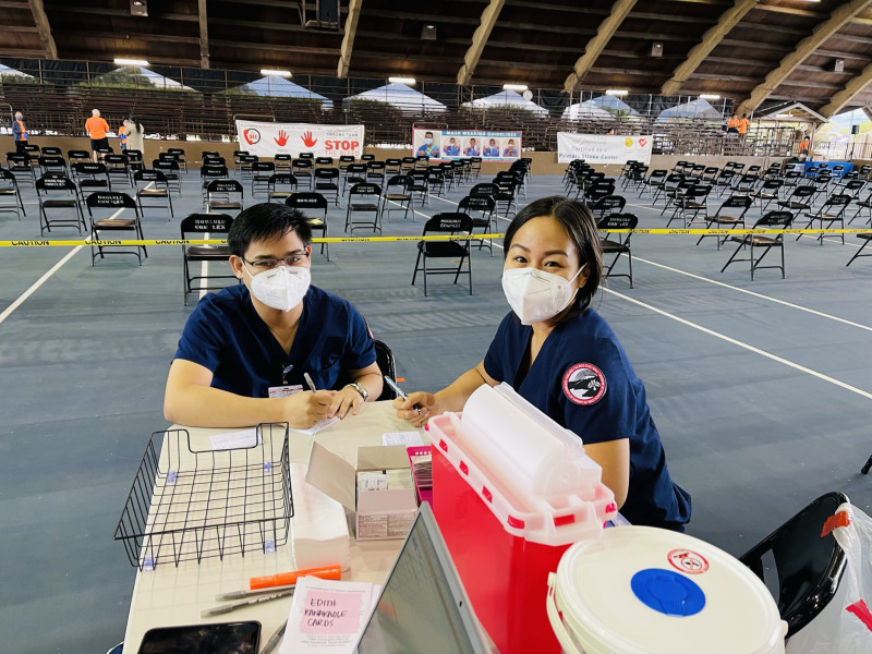 Rod Neil Burbano and one of his classmates volunteering during the mass COVID-19 vaccination at Edith Kanaka'ole Multipurpose Stadium.