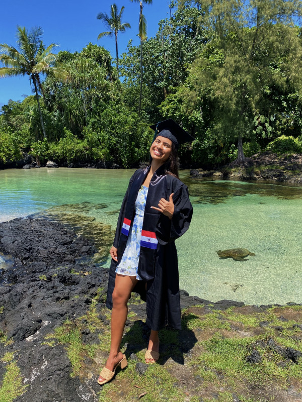 Sofia with her cap and gown at the beach in Hilo.