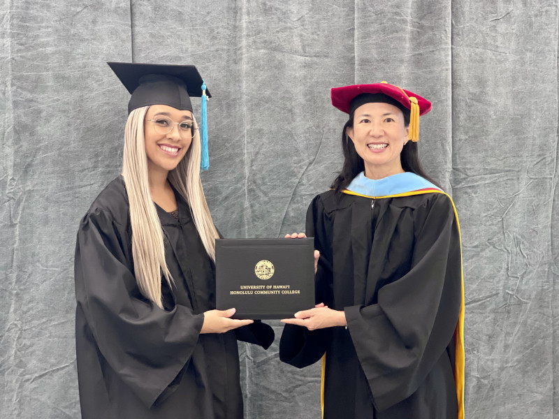 Nicole and chancellor holding diploma