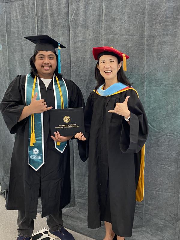 Me wearing my cap and gown receiving my diploma from Chancellor Lee