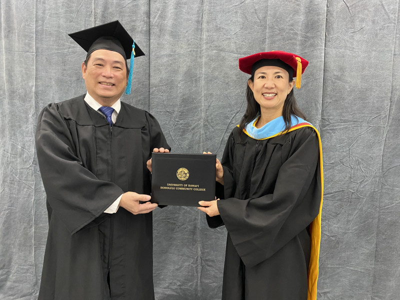 Picture of Chancellor Lee and me holding my diploma.