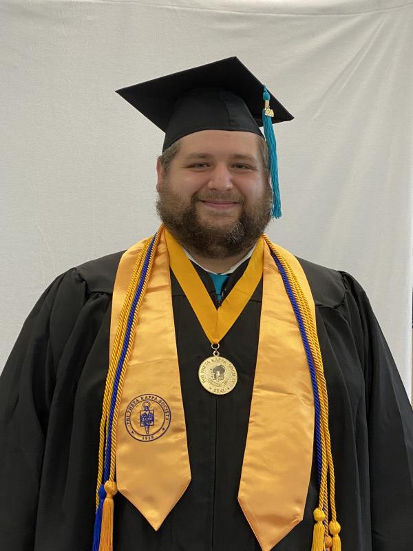Man in graduation regalia smiling
