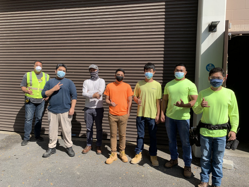 I'm standing on HCC campus with my classmates and wearing my construction outfit and blue mask. Last one on the right side.