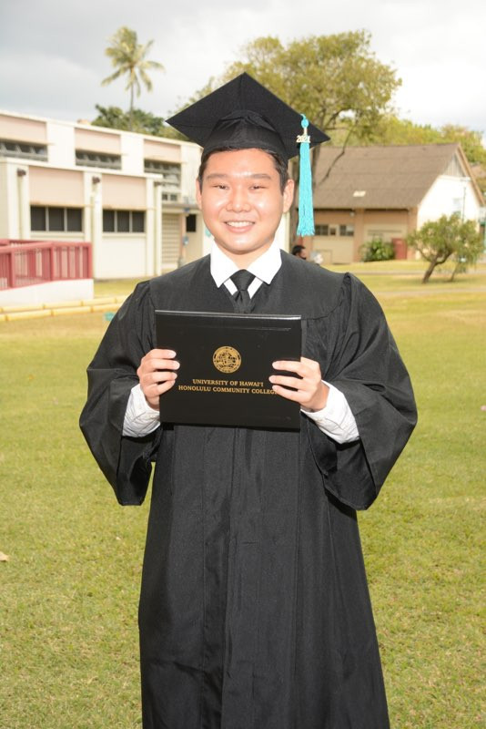 I'm standing on HCC campus and wearing my cap and gown.