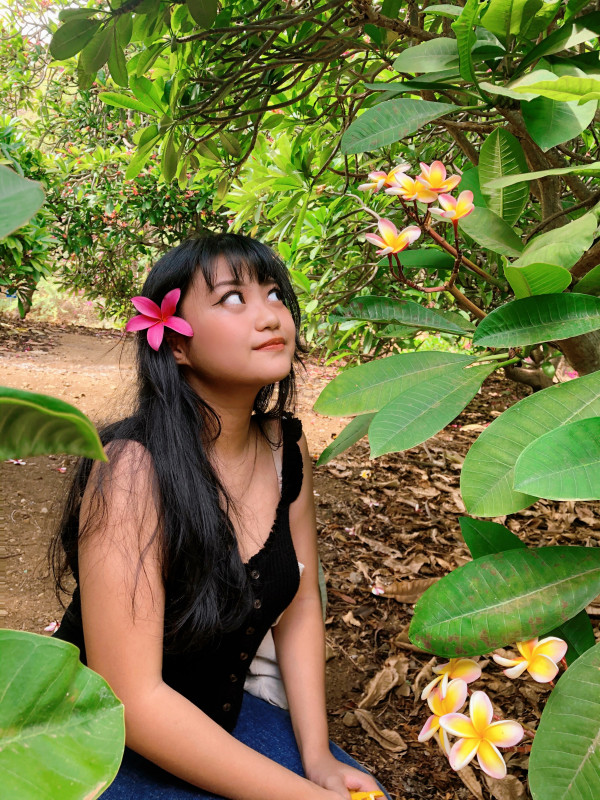 Me standing next to a plumeria tree