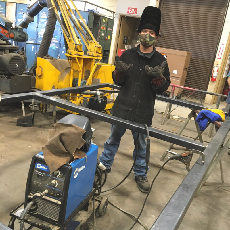 Me standing in the frame of a gate at our weld shop