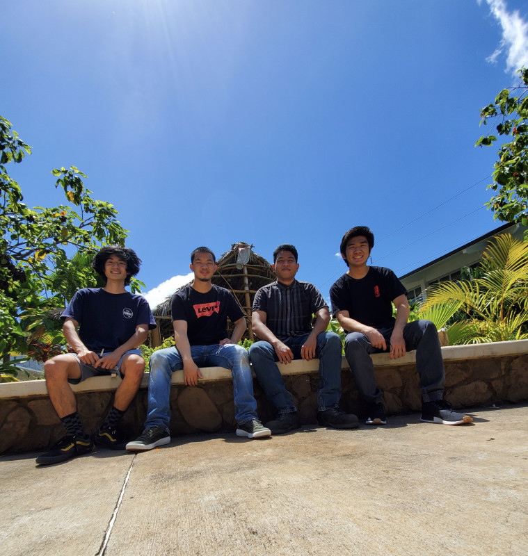 Me and my friends Austin, Jordan, and Reyn sitting on a wall in front of the colleges hale