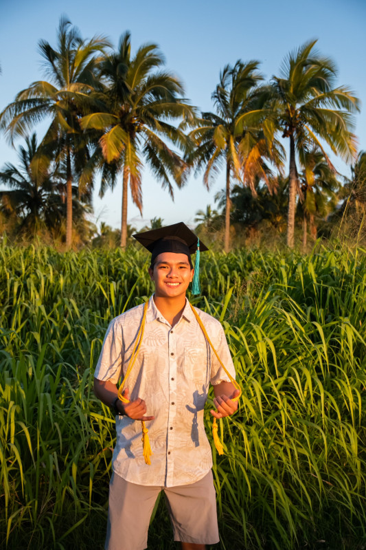 Picture of me in Palm Tree Forest with a beautiful view of Mt. Ka'ala in the background