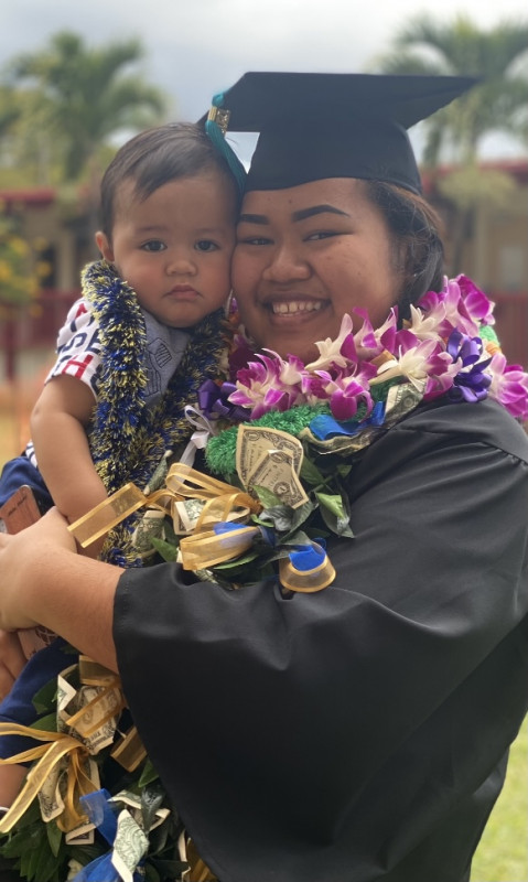 A photo of me and my nephew at my grad picture day