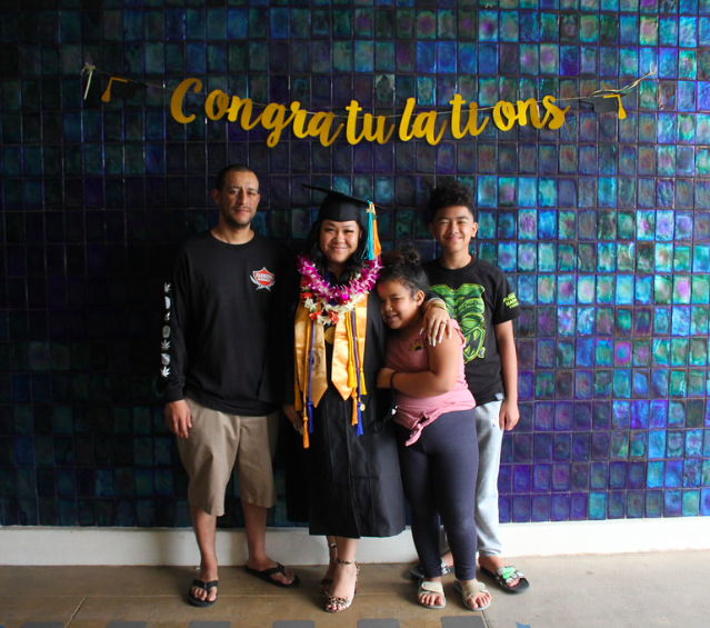 A picture of my family and I with congratulations sign.