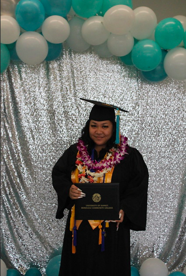 A picture of me holding my diploma.