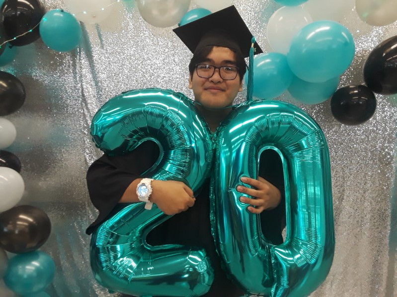 Me holding a teal balloon shaped like a "20"