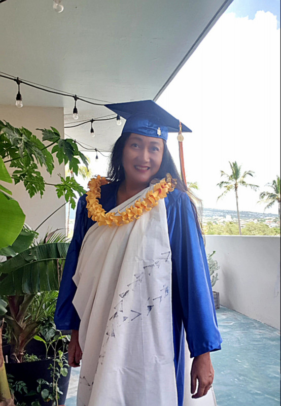 Aidha in kīhei and graduation gown and cap