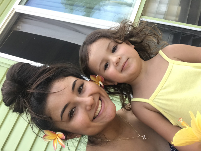 My baby sister and I selfie with flowers in our ears
