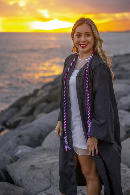 cap and gown by water