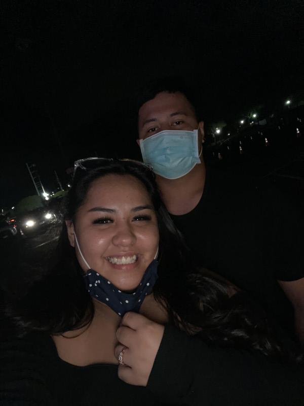 Graduate Tiana is smiling with her soon to be husband dylan at the christmas light show.