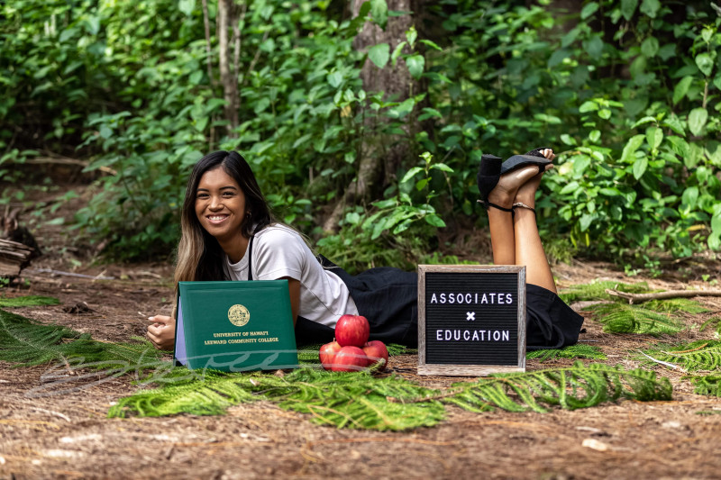 Laying on the grass, next to my diploma and representations of my future career.